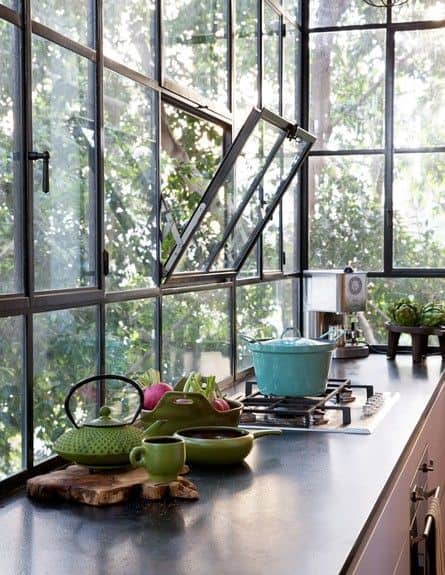 Cozinha bem iluminada com janela de ferro