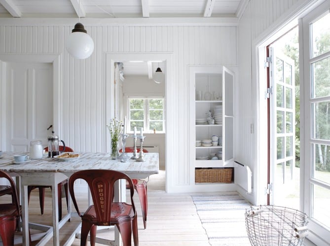 sala de jantar com paredes de madeira pintadas de branco