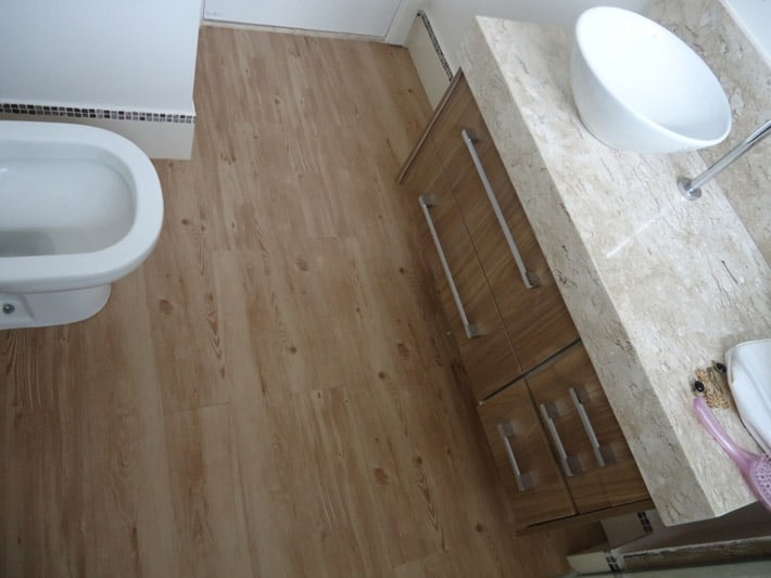 banheiro com piso de PVC que imita madeira