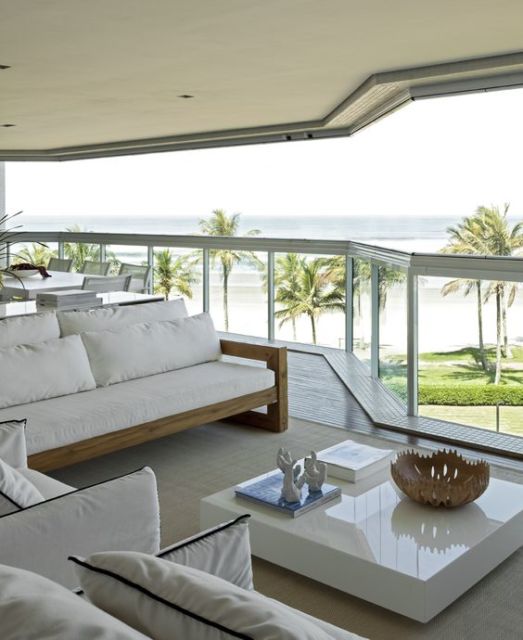 Casas de praia: Decoração de luxo com sofá branco