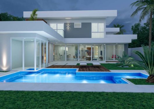 Casas com piscina: casa em l branca e cinza