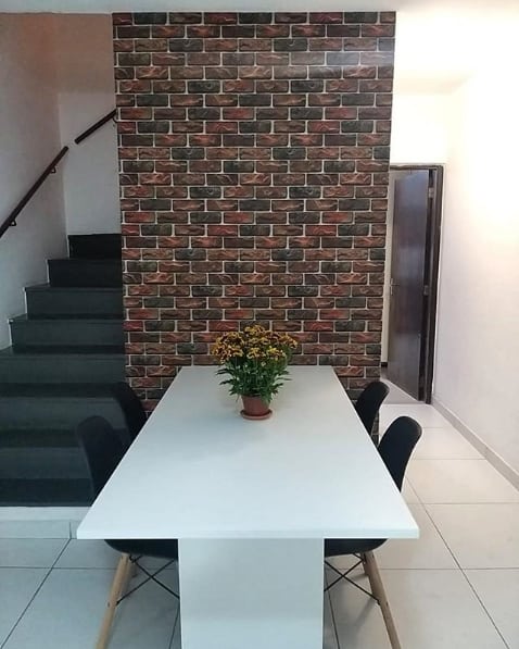 sala de jantar simples com papel de parede de tijolos
